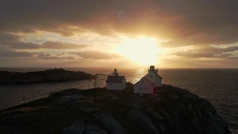 Arctic Ocean Sunset Behind Lighthouse on Rocky Coast of Norway Stock-Footage 321708848