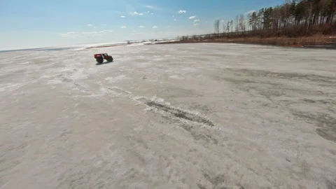 Arctic Rush. A car with large, low-pressure tires. FPV Aerial Drone shot Stock Footage 262637917