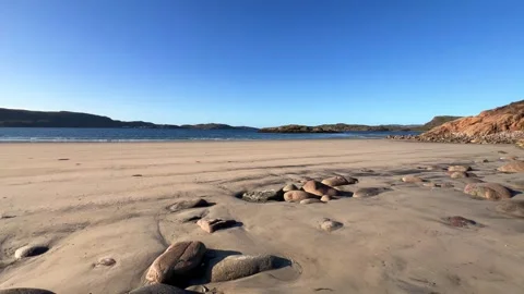 An Arctic sandy beach with large rocks in the foreground. Tundra.  Stock Footage 274337177