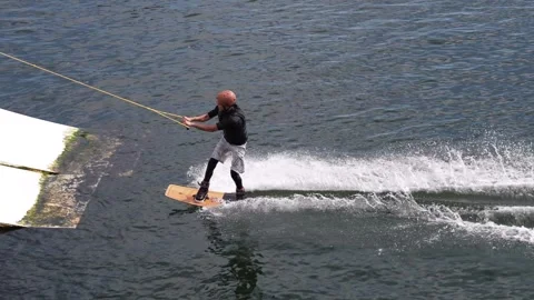 Arder ride on cable wakeboard in park, outdoor extreme on water Stock Footage 247513605