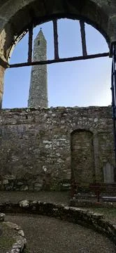 Ardmore Round Tower framed through ancient stone arch in Ireland Stock Photos