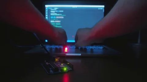 Arduino Board with Blinking Red Diode. On the Background of Man's Hands Typin 스톡 동영상 85123616