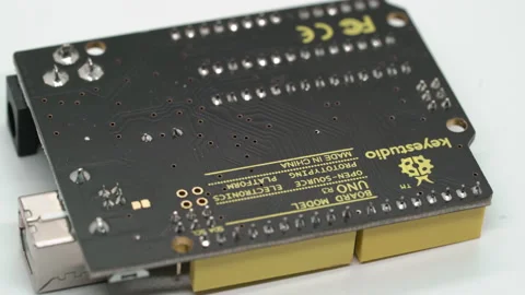 Arduino UNO electronic component. Small single board computer, device for study. Stock Footage 169672767