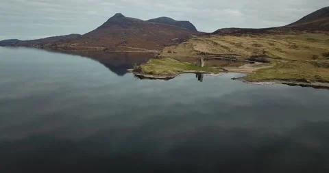 Ardvreck Castle short pan back with reflection Stock Footage 153430759