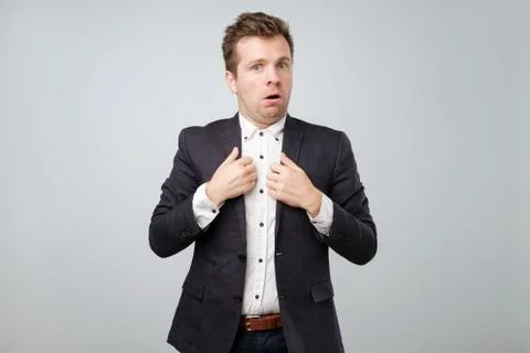 Are you accusing me, it was not my fault. Confused attractive man in suit shr Stock Photos