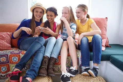 Are you guys ready for a selfie. a group of teenage friends using a cellphone Stock Photos