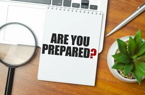 Are You Prepared text on notepad and laptop on wooden background Stock Photos