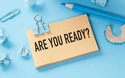 ARE YOU READY text on a piece of paper on blue background Stock Photos
