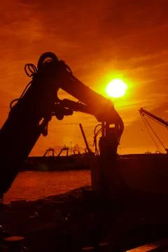 Area of ​​excavating machines, sunset Stock Photos