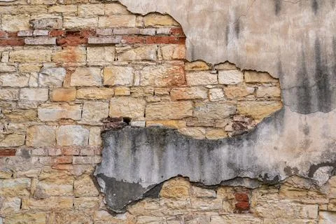 An area of old stone and bricks and interestingly colored old plaster Stock Photos