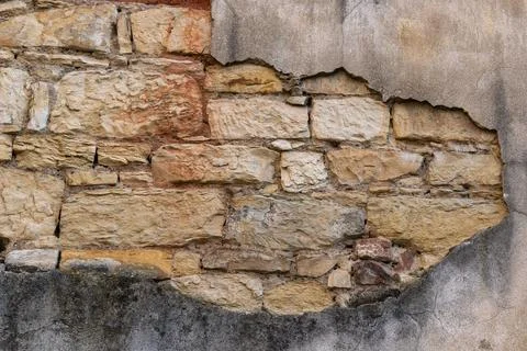 An area of old stone and interestingly colored old plaster 스톡 사진