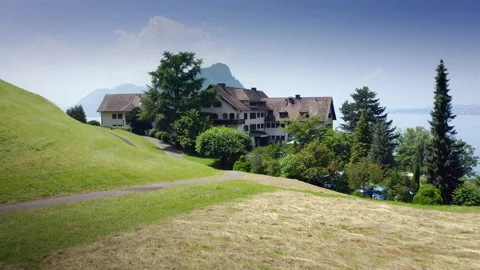 Areal Drone Flight over Hotel FloraAlpina Vitznau to Lake Lucerne and Swiss Alps Stock Footage 157762563