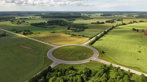 Areal drone shot of cloud shadows moving accross rural intersection, summer 2026 Stock Footage 338187251