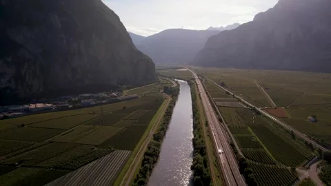 Areal footage of traffic on road surrounded by alps Video stock 252150029