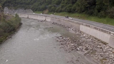 Areal footage of traffic on road surrounded by alps 스톡 동영상 252151883