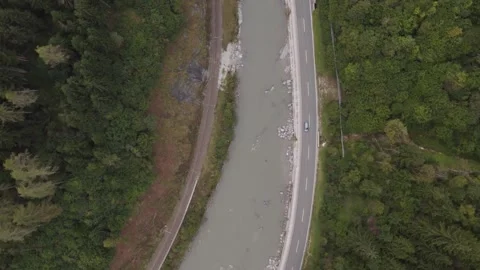 Areal footage of traffic on road surrounded by alps 스톡 동영상 252151920