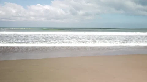 Areal Ocean view from drone. Sandy beach, big waves, blue sky, white clouds Stock Footage 159591770