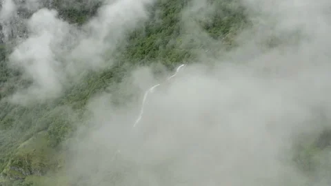 Areal shoot of drone flying from clouds and making a parallax move around Stock Footage 140332138
