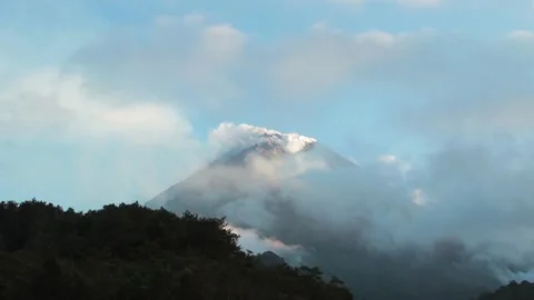 Arenal volcano erupting at sunset timelapse, dynamic clouds moving around v.. Stock Footage 337634619