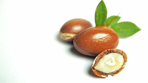 Argan nuts with green leaves motion on white background. Stock Footage 165780183