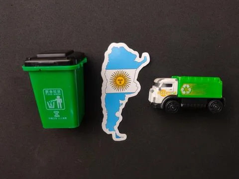 Argentina map sticker positioned between a miniature green food waste bin a.. Stock Photos