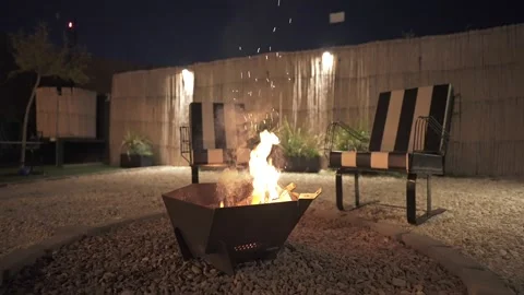 Argentina. Outdoor fire pit setting with lounge chairs surrounding. Slow motion Stock Footage 339754260
