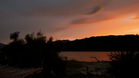 Argentina red sky reflected in lake Vídeos de archivo 107916355