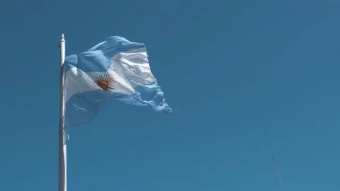 Argentine flag flying on a flagpole on a sunny day with clear skies Stock Footage 237020140
