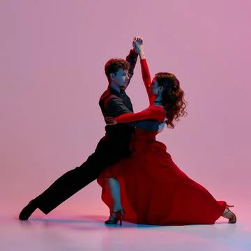 Argentine tango dancers in dramatic pose against pink and purple gradient Stock Photos