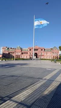 Argentinian flag waving in front of the Pink House in Buenos Aires. Stock Photos