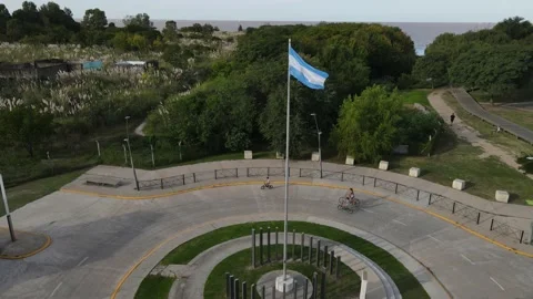 Argentinian flag waving in slow motion, family riding bicycles and with green Stock Footage 153785842
