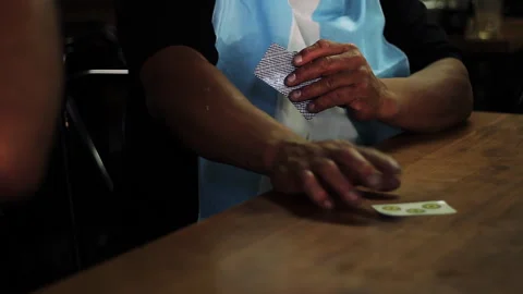 Argentinian Men Playing Truco Card Game On Rustic Wooden Table - 4K Stock Footage 334136794