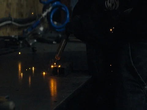 ARGON WELDING. A blacksmith or welder, with his welder, welding steel and iron Stock Footage 77917133