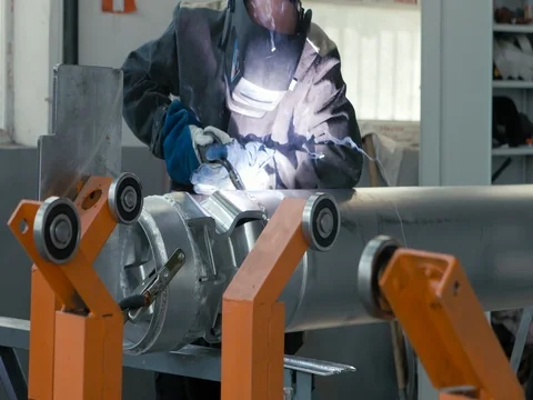 ARGON WELDING. A blacksmith or welder, with his welder, welding steel and iron Stock Footage 77926011
