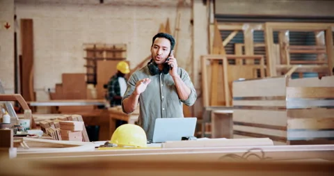 Argument, carpentry and phone call with man in workshop for disagreement or Stock Footage 331570323
