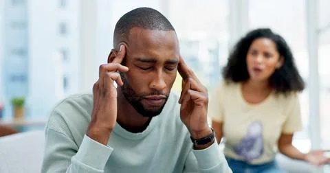 Argument, headache and man on sofa in home with infidelity, cheating or toxic Stock Photos