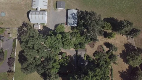 Arial birds eye view of a property with a white barn Stock Footage 104266873