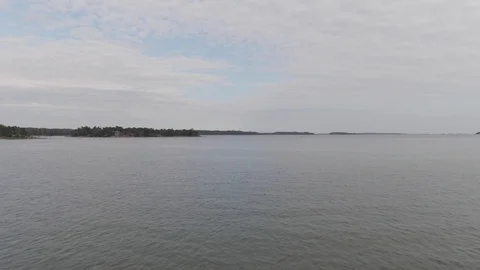 Arial drone shot. Flying over water. Sea waves, coast and forest. Stock Footage 114763163