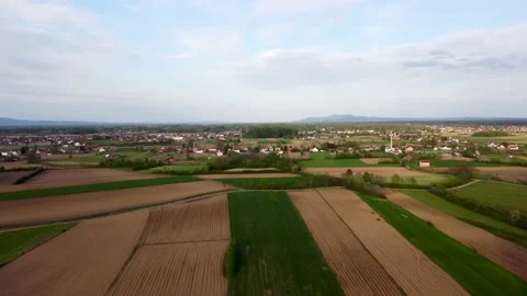 Arial drone view of freshly plowed fields near village. Plowed farm land Stock Footage 153335260