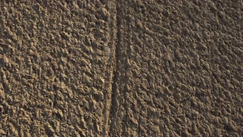 Arial drone view of freshly plowed field ready for new planting and seeding Stock Footage 153372103