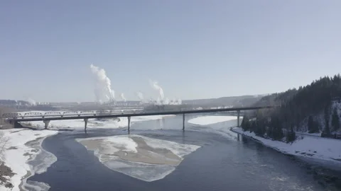 Arial  footage moving down from Concrete Bridge Over A Small River and Pulp mill Stock Footage 145961521