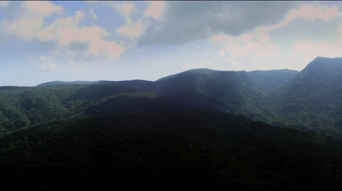 Arial of mountain hills covered in forest with dark clouds Video stock 28840967