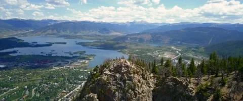 Arial over the mountain into a mountain town in Colorado with a lake Stock Footage 134912461
