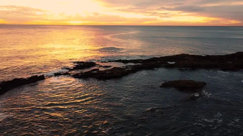 Arial pan of sunset over rocky ocean Video stock 149283437
