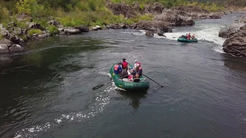 Arial of a raft going through rapids 2 Stock Footage 103739379