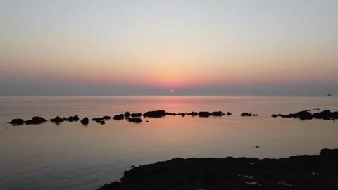 Arial shot of Arabian gulf at early sunrise hovering over calm water Stock Footage