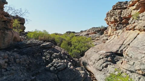 Arial shot: Fly through of a rock formation in a semi arid area. UHD50p Stock Footage 247966248