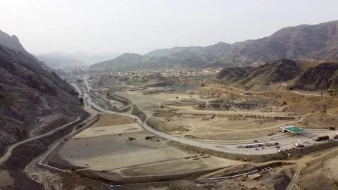 Arial shot of Tor Kham border crossing with Pakistani flag at Afghan border  Stock Footage 199270864