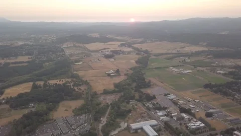 Arial of sun setting behind fire smoke Stock Footage 103868491