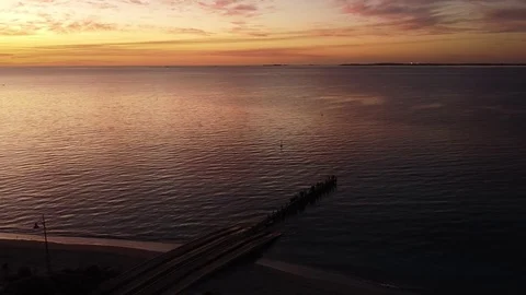 Arial sunset at Long Point Jetty with people fishing and swimming, Port Kenne Stock Footage 130013786